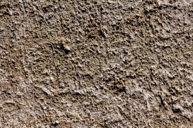 Eskinin dokusu açık kahverengi ve gri beton ile küçük tahıllı duvar kağıdı karışımı.