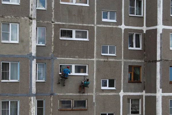 Les grimpeurs réparent les fenêtres dans un immeuble de grande hauteur . Photo De Stock