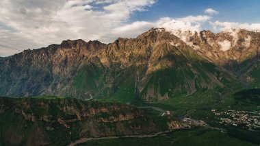 green mountains with cloudy sky clipart