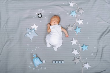 overhead view of adorable sleeping infant baby with decorations around clipart