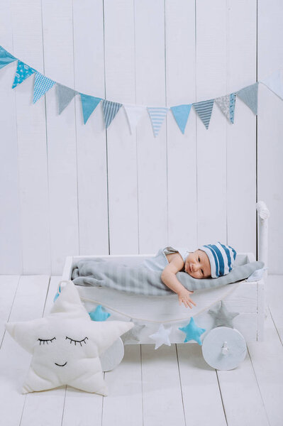innocent little infant baby lying in wooden baby cot