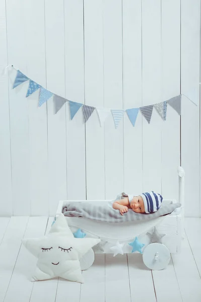 Innocent little infant baby lying in wooden baby cot — Stock Photo