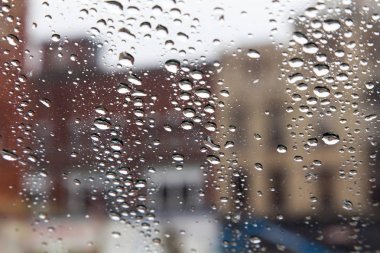 city buildings through rain on window clipart