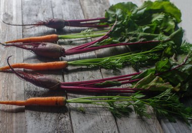 Top görünümü taze organik pancar ve rustik ahşap arka plan, sağlıklı yaşam, sonbaharda hasat, çiğ sebzeler, havuç