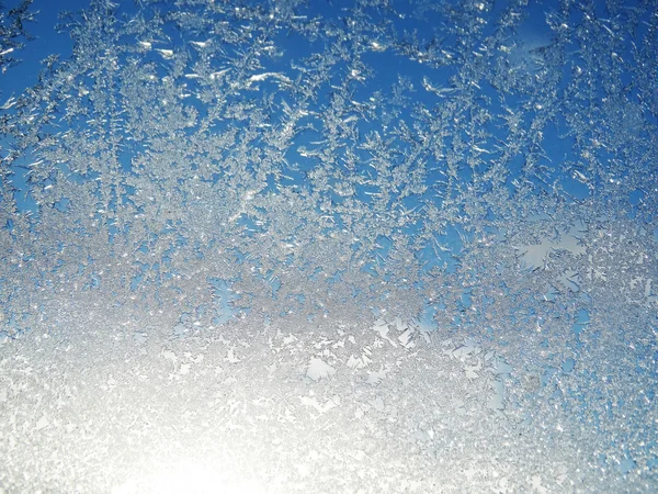 Snowflakes on glass as winter texture background — Stock Photo, Image