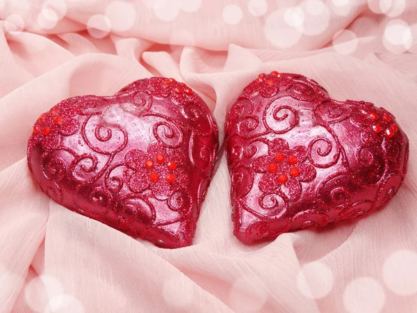 Hearts on pink silk material background love concept Stock Photo