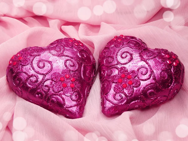 Hearts on pink silk material background love concept Royalty Free Stock Photos