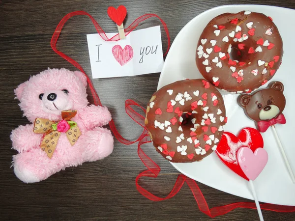 Dia dos namorados donuts de chocolate ursinho e cartão de saudação — Fotografia de Stock