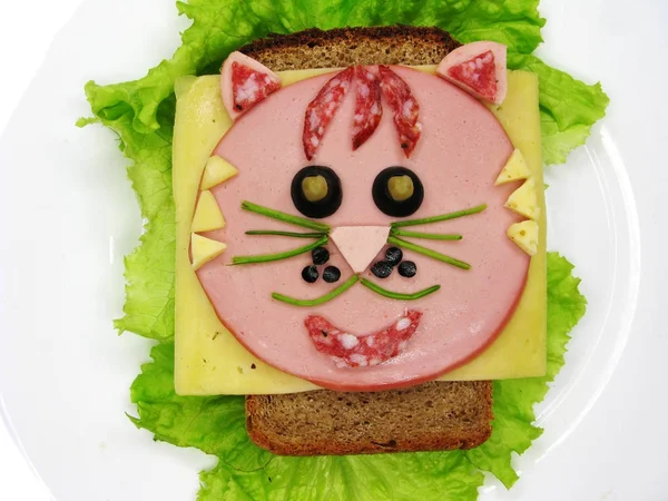creative food sandwich with sausage and cheese served on lettuce