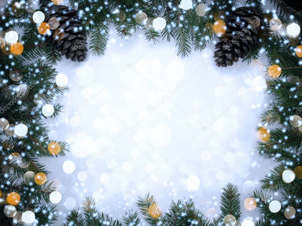 christmas garland lights on fir branches on wooden background