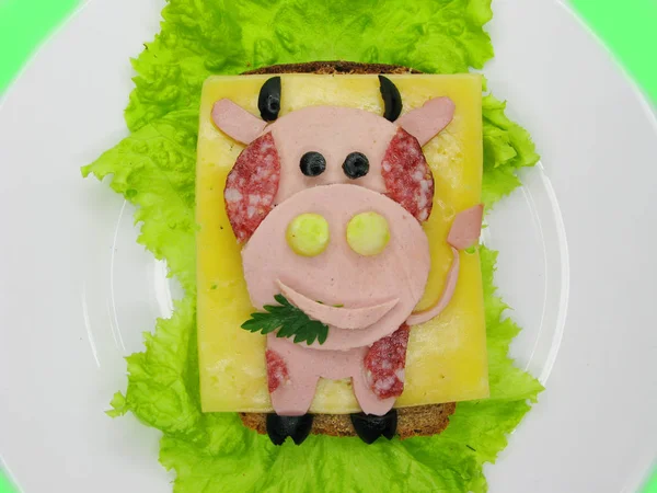 creative food sandwich with sausage and cheese served on lettuce