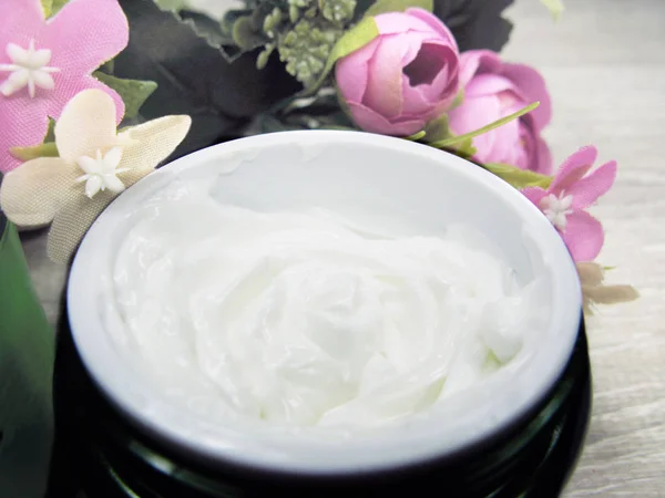Cosmetic cream for face care and rose flowers Stock Image