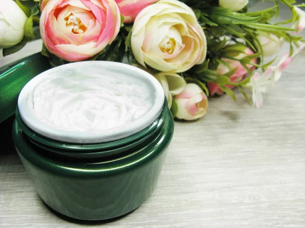 Crema cosmética para el cuidado de la cara y flores de rosas —  Fotos de Stock