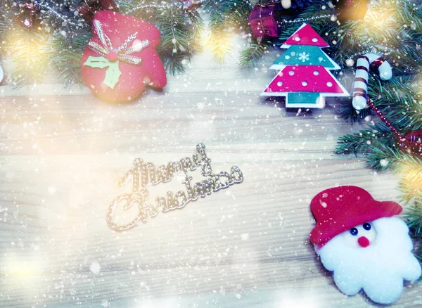 Christmas decoration and snow on wooden background — Stock Photo, Image