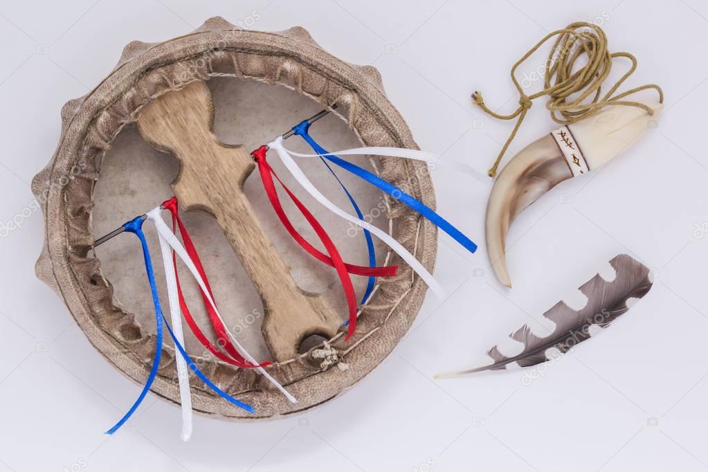 Ritual objects of shamanism. Assistants shaman in travel - tambourine, bear claw, bird feather