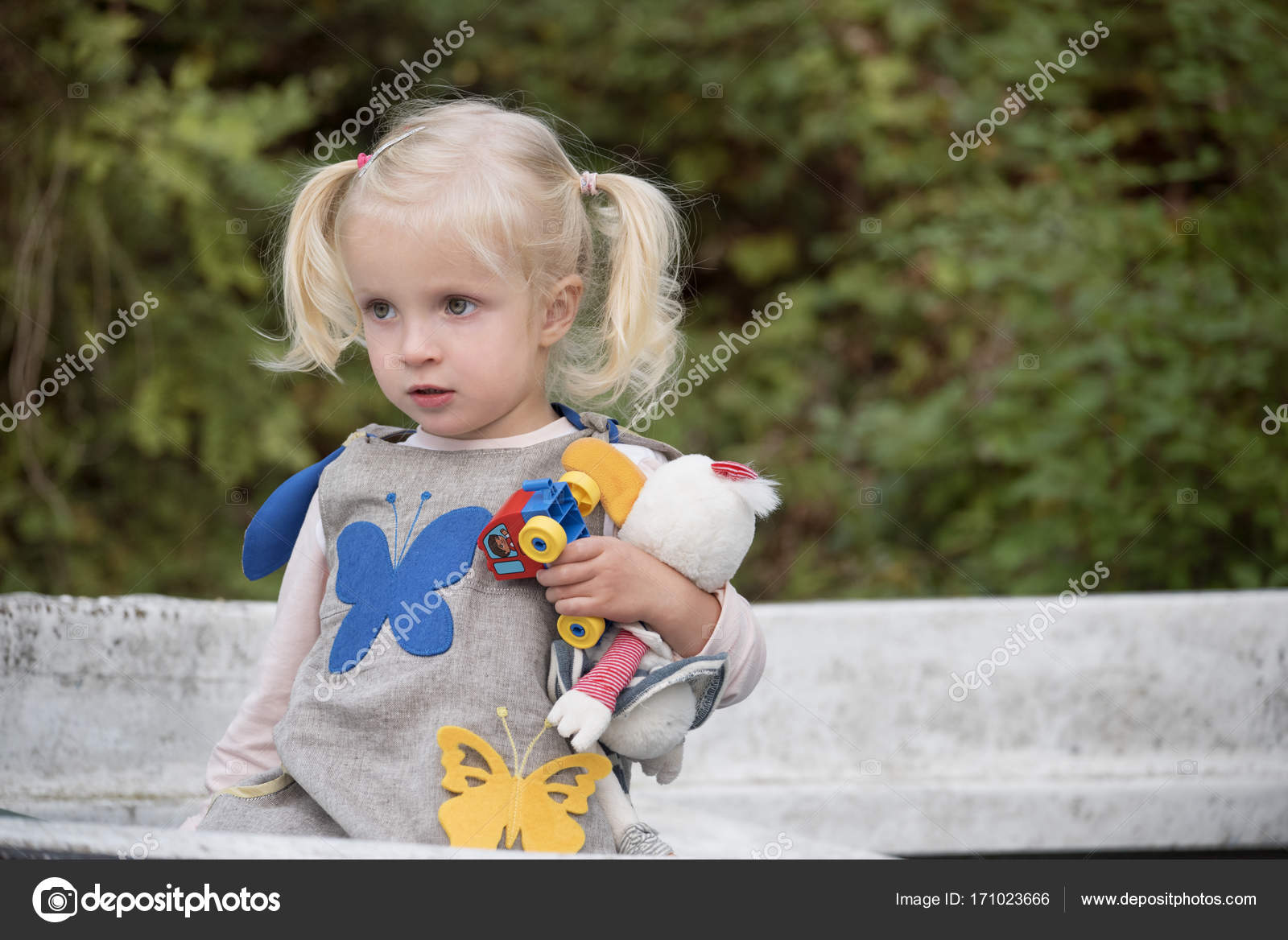 Beautiful Thoughtful Little Girl With Her Toys Child Girl Blonde
