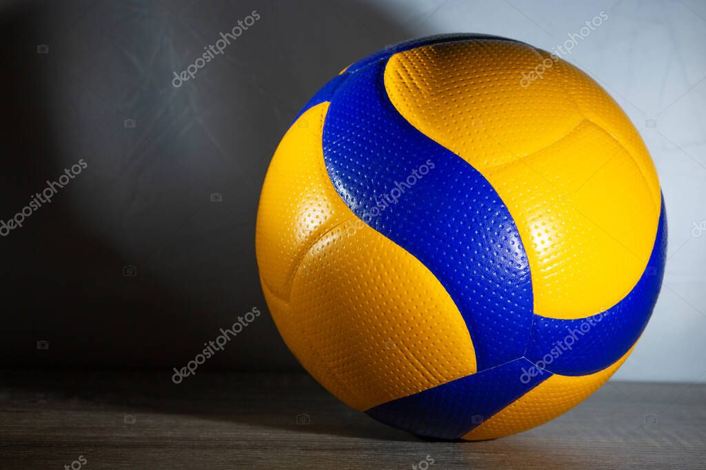 Blue and yellow ball on the grey background. Sport