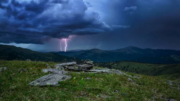 A lightning strike in the mountains of the dark sky