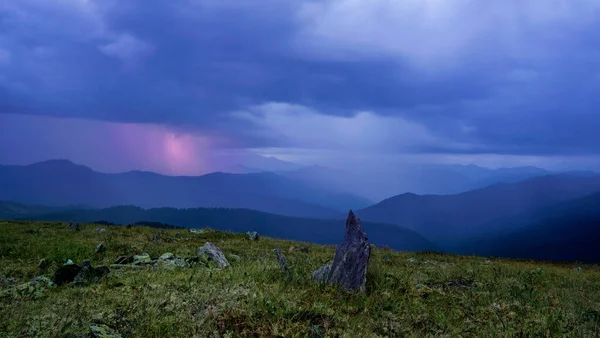 A lightning strike far in the mountains the rain