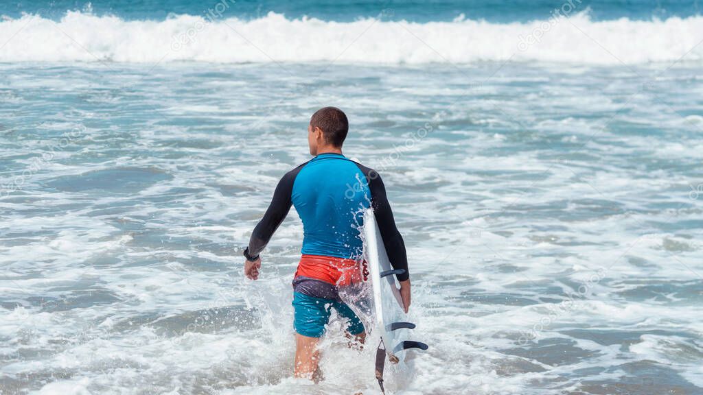 Guy goes surfing in the ocean