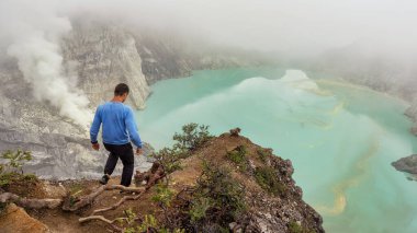 Man goes on the trail ijen smoke sulfuric acid lake Indonesia the island of Java