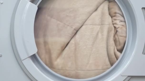 Drying laundry clothes. Close up of drying machine. Closeup of industry washing machine. Uniform turning in dryer machine. Dryer laundry machine. Laundry washing clothes — Stock Video