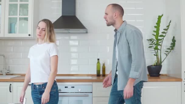 Hombre agresivo discutiendo con su esposa en la cocina de lujo. Enojado marido teniendo conflicto con la esposa — Vídeo de stock