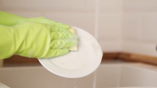 Close up hands of woman washing dishes in kitchen — Stock Video