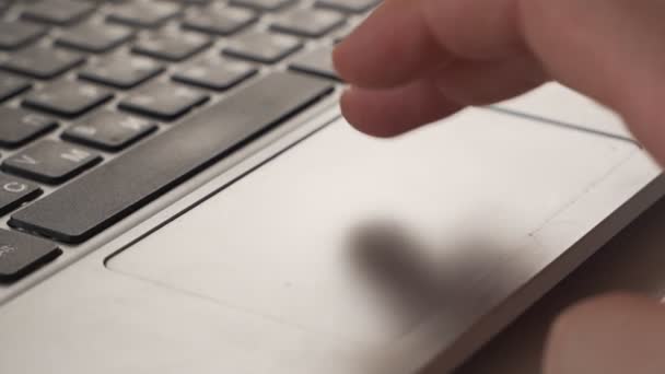 Close up shot of man scrolling a Website Using Laptop Track Pad — Stock Video