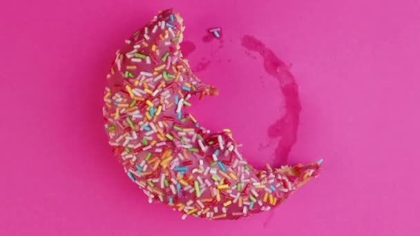 Detener movimiento creativo concepto video animación donut mordida sobre fondo rosa . — Vídeos de Stock