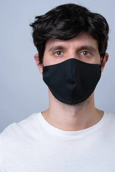 Uomo in maschera medica nera, isolato su sfondo grigio — Foto Stock