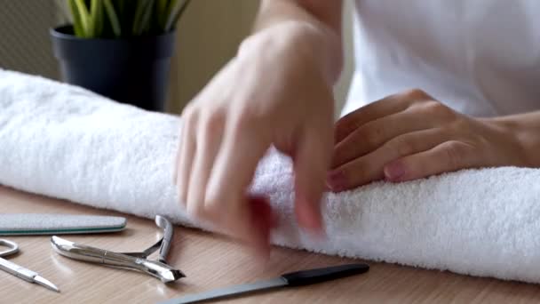 Manicure. Woman is doing manicure and using nail file. Skin care, hygiene. Spa, nail salon. Home care. Beauty. — Stock Video