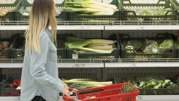 Woman buying leek at the market