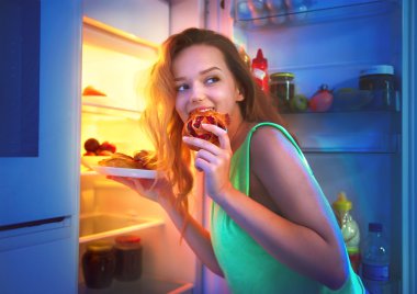 girl taking food from refrigerator at night