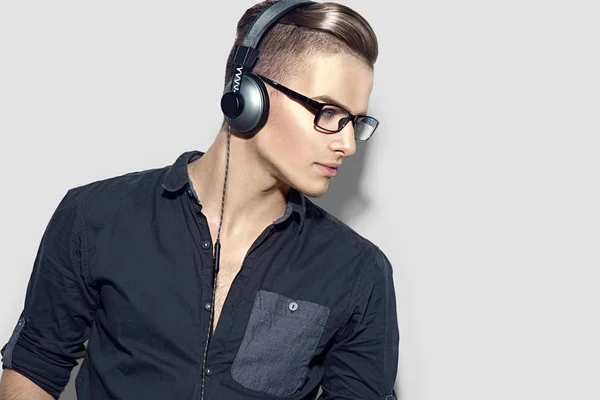 Young Man Enjoying Music Headphones Gray Background — Stock Photo, Image