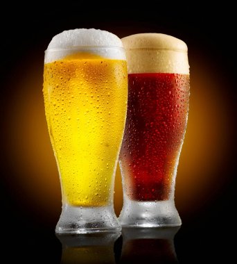 Craft beer. Two glasses of cold light and dark beer isolated on black background clipart