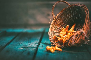 Ham vahşi chanterelles mantar sepeti eski rustik arka plan üzerinde