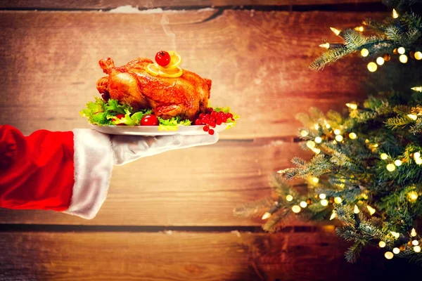 Santa Hand Holding Roasted Chicken Wooden Background Christmas Tree — Stock Photo, Image