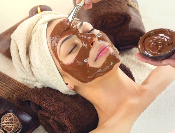 Young Woman Relaxing Spa Salon Applying Chocolate Face Mask Royalty Free Stock Images