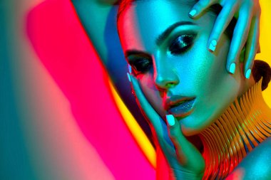 Fashion model in colorful bright lights with trendy make-up clipart