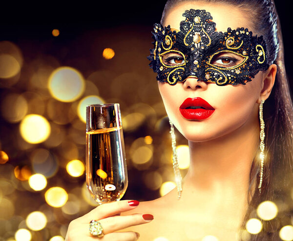 woman with glass of champagne and lace masquerade mask on face