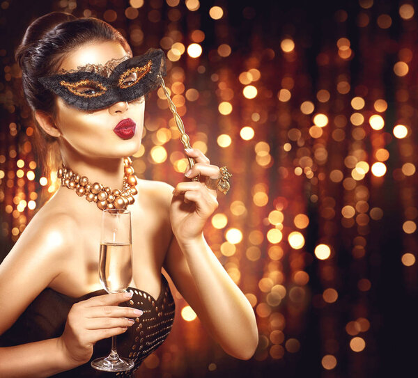 woman with glass of champagne and lace masquerade mask on face