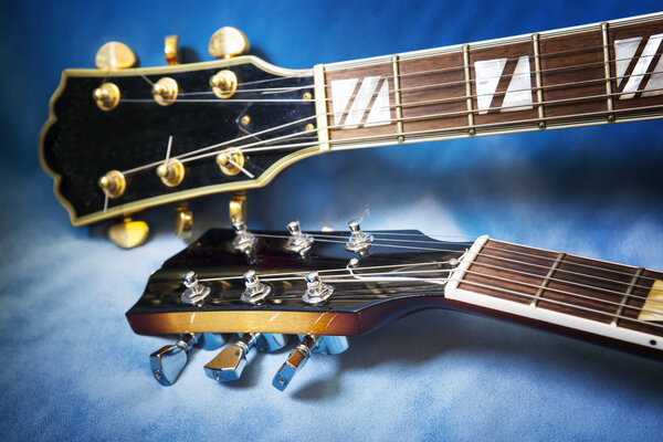 Acoustic guitars close up in blue background