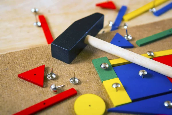 Blocks, hammer and nails on a table — Stock Photo, Image