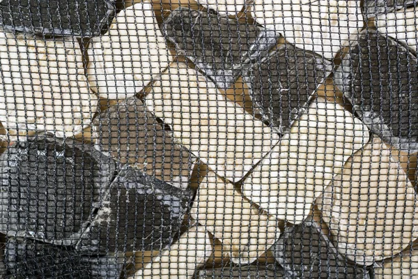 Tile from dolomite stones on a grid — Stock Photo, Image