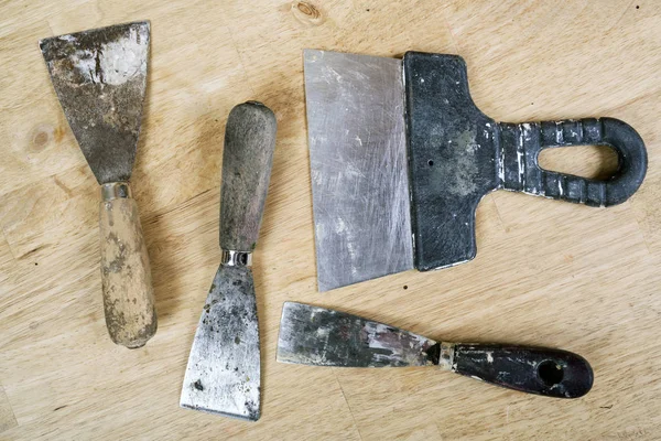 Set of putty knifes on wooden background — Stock Photo, Image