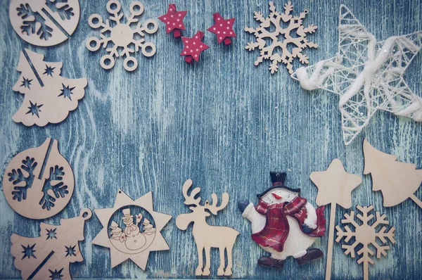 Christmas wooden figures on blue wooden background
