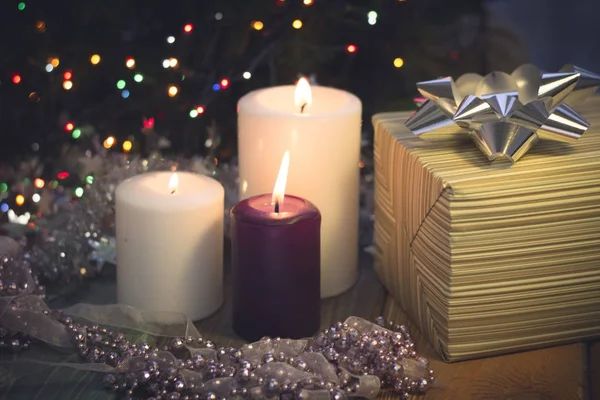 Natureza morta com velas acesas, decorações de Natal e uma caixa de presente — Fotografia de Stock