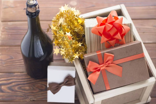 New year surprise in a box with a bottle of champagne and gifts