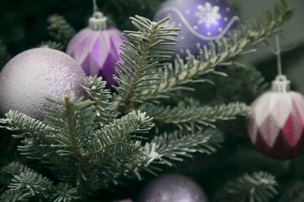 Holiday background with baubles on a Christmas tree — Stock Photo, Image